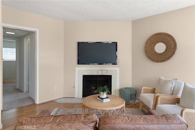 330 34th Pl, Manhattan Beach, CA 90266 - living area with wood finished floors, a tiled fireplace, and a textured ceiling