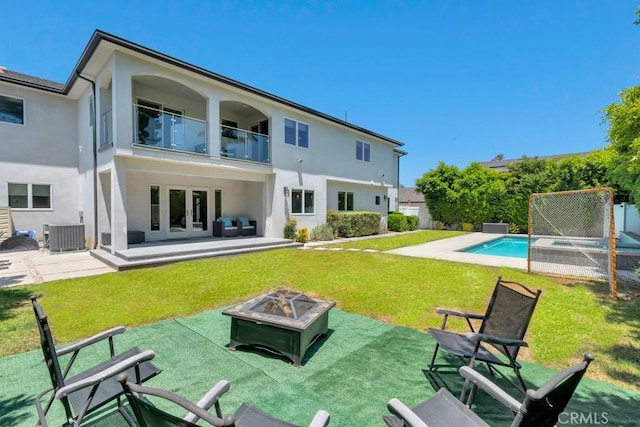 15460 La Maida St, Sherman Oaks, CA 91403 - back of house with a balcony, an outdoor pool, stucco siding, a yard, and french doors