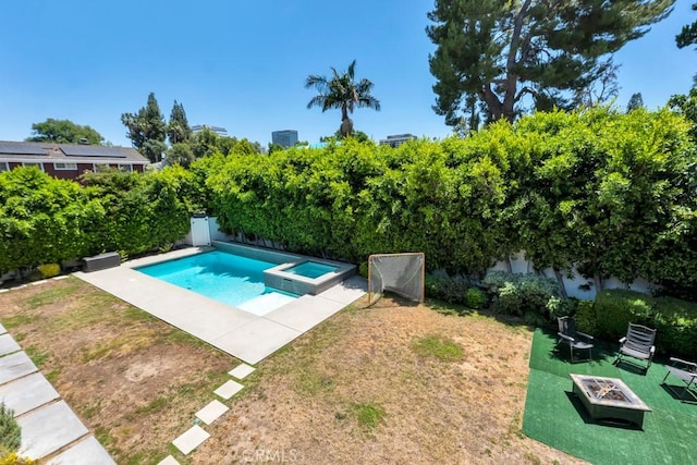 15460 La Maida St, Sherman Oaks, CA 91403 - view of swimming pool featuring an outdoor fire pit, a lawn, and a pool with connected hot tub