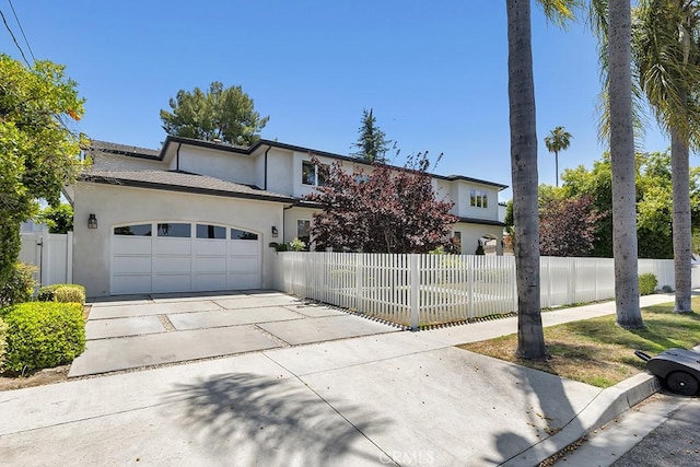 15460 La Maida St, Sherman Oaks, CA 91403 - view of front of home featuring stucco siding, driveway, and a garage