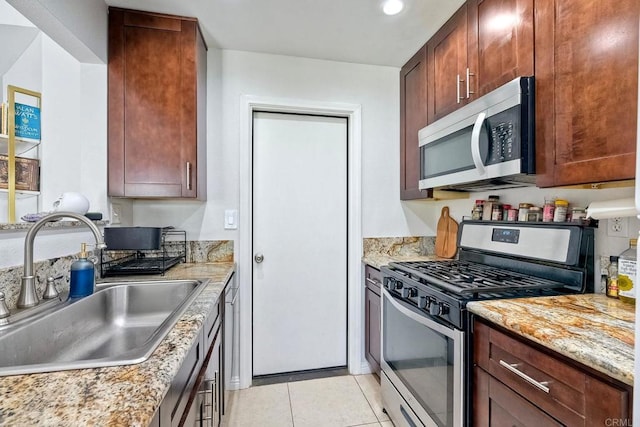 1219 Paseo Hermosa, Oceanside, CA 92056 - kitchen featuring stainless steel appliances, light tile patterned flooring, and light stone countertops