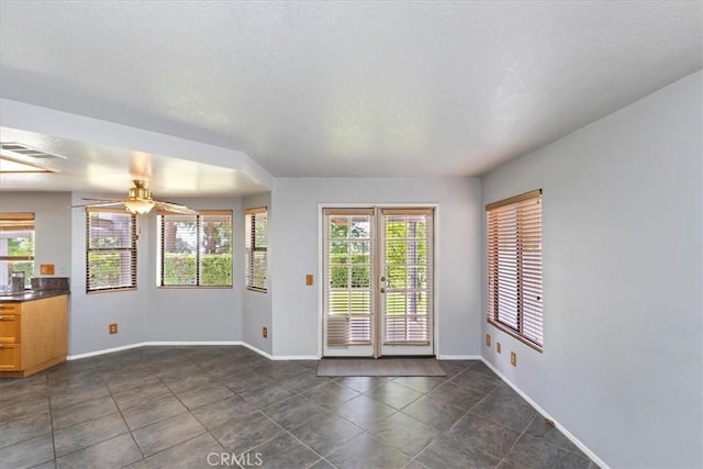 10151 Saddlehill Ter, Rancho Cucamonga, CA 91737 - unfurnished dining area with healthy amount of natural light, ceiling fan, and dark tile patterned floors