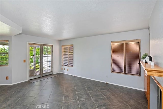 10151 Saddlehill Ter, Rancho Cucamonga, CA 91737 - spare room with dark tile patterned flooring and a textured ceiling