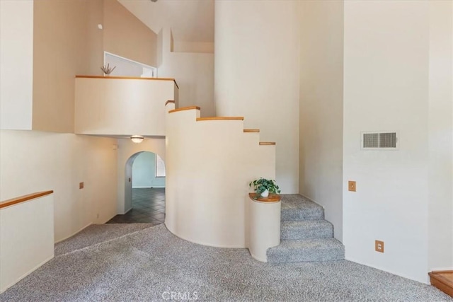 10151 Saddlehill Ter, Rancho Cucamonga, CA 91737 - staircase with arched walkways and carpet flooring