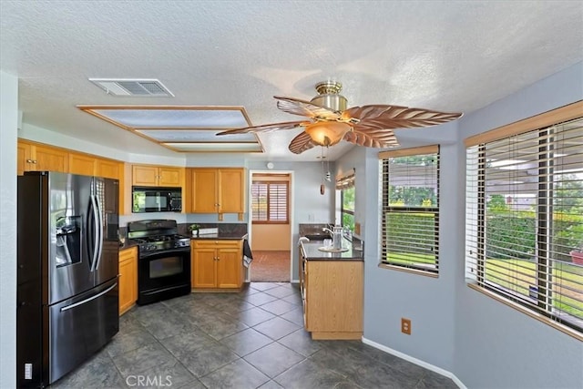 10151 Saddlehill Ter, Rancho Cucamonga, CA 91737 - kitchen with black appliances, dark countertops, a ceiling fan, a textured ceiling, and dark tile patterned flooring