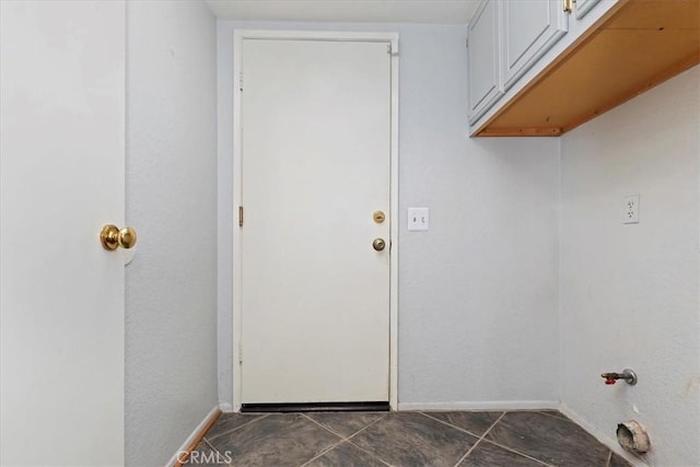 10151 Saddlehill Ter, Rancho Cucamonga, CA 91737 - washroom featuring cabinet space and dark tile patterned flooring