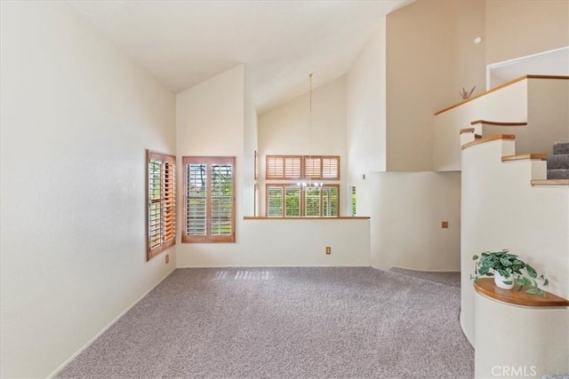 10151 Saddlehill Ter, Rancho Cucamonga, CA 91737 - empty room with high vaulted ceiling, carpet flooring, stairs, and a chandelier