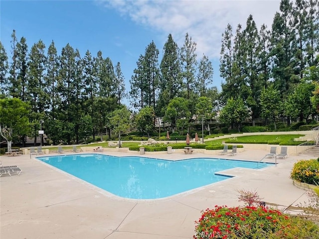 10151 Saddlehill Ter, Rancho Cucamonga, CA 91737 - community pool featuring a patio area and view of wooded area