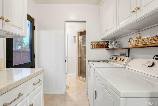 26114 Delos Dr, Torrance, CA 90505 - washroom featuring washer and dryer, cabinet space, and light tile patterned floors