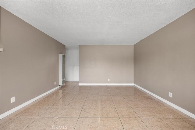 1163 W 3rd St, Pomona, CA 91766 - spare room featuring a textured ceiling and baseboards