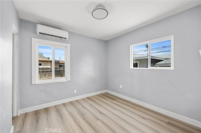 1163 W 3rd St, Pomona, CA 91766 - empty room featuring a wall mounted air conditioner and wood finished floors