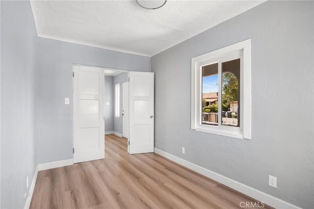 1163 W 3rd St, Pomona, CA 91766 - unfurnished bedroom featuring baseboards and wood finished floors
