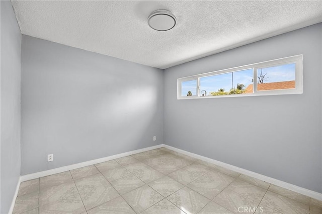 1163 W 3rd St, Pomona, CA 91766 - spare room featuring a textured ceiling and baseboards