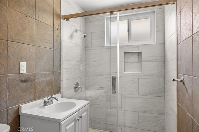1163 W 3rd St, Pomona, CA 91766 - bathroom with a shower stall, vanity, and tile walls