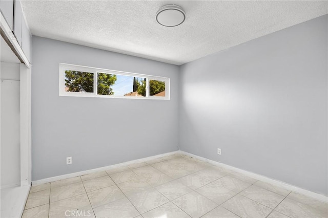 1163 W 3rd St, Pomona, CA 91766 - spare room with a textured ceiling
