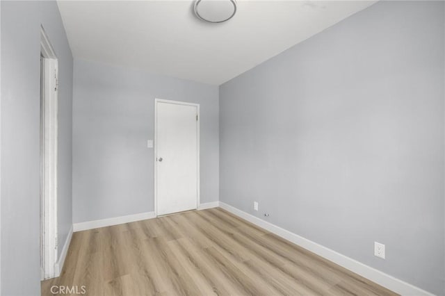 1163 W 3rd St, Pomona, CA 91766 - unfurnished room featuring baseboards and light wood-style flooring