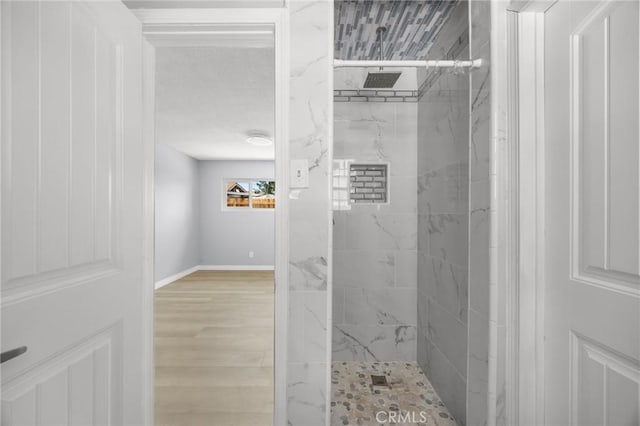 1163 W 3rd St, Pomona, CA 91766 - bathroom featuring a marble finish shower and wood finished floors