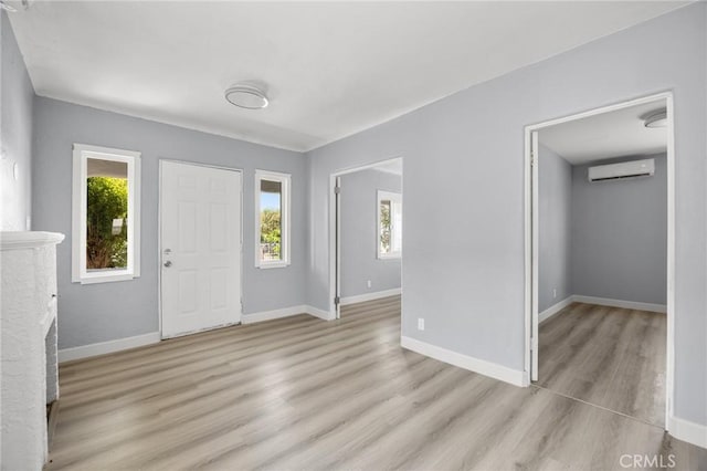 1163 W 3rd St, Pomona, CA 91766 - entrance foyer featuring an AC wall unit and light wood-type flooring