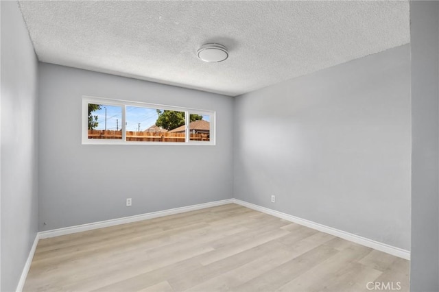 1163 W 3rd St, Pomona, CA 91766 - spare room featuring wood finished floors and a textured ceiling