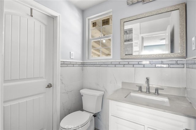 1163 W 3rd St, Pomona, CA 91766 - half bathroom with vanity, tile walls, and wainscoting