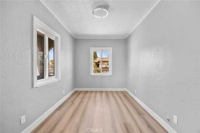 1163 W 3rd St, Pomona, CA 91766 - spare room featuring light wood-style floors and a textured ceiling