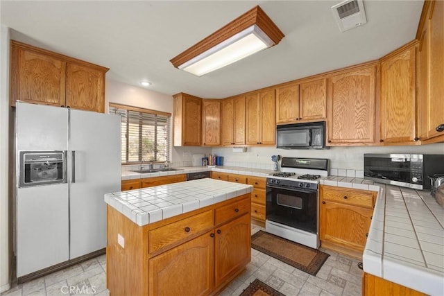 21276 White Pine Dr, Tehachapi, CA 93561 - kitchen with white appliances, tile countertops, a center island, and recessed lighting