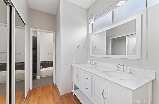 4705 Kester Ave Unit 209, Sherman Oaks, CA 91403 - bathroom featuring double vanity, wood finished floors, and a bath