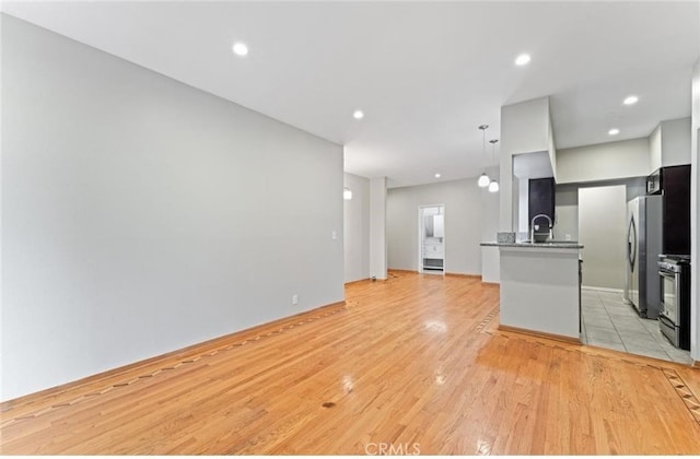 4705 Kester Ave Unit 209, Sherman Oaks, CA 91403 - unfurnished living room with light wood-style floors and recessed lighting