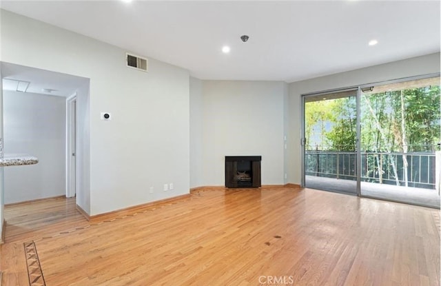 4705 Kester Ave Unit 209, Sherman Oaks, CA 91403 - unfurnished living room featuring light wood-style flooring, a fireplace, and recessed lighting