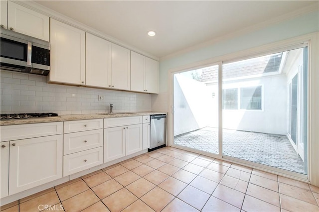 24 Queens Wreath Way, Irvine, CA 92612 - kitchen featuring appliances with stainless steel finishes, white cabinetry, decorative backsplash, light tile patterned floors, and recessed lighting