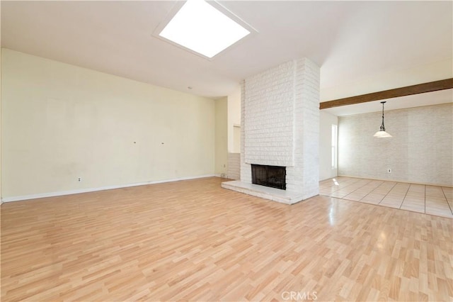 24 Queens Wreath Way, Irvine, CA 92612 - unfurnished living room featuring light wood-style floors and a fireplace
