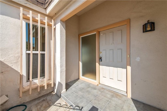 24 Queens Wreath Way, Irvine, CA 92612 - view of exterior entry with stucco siding and a patio