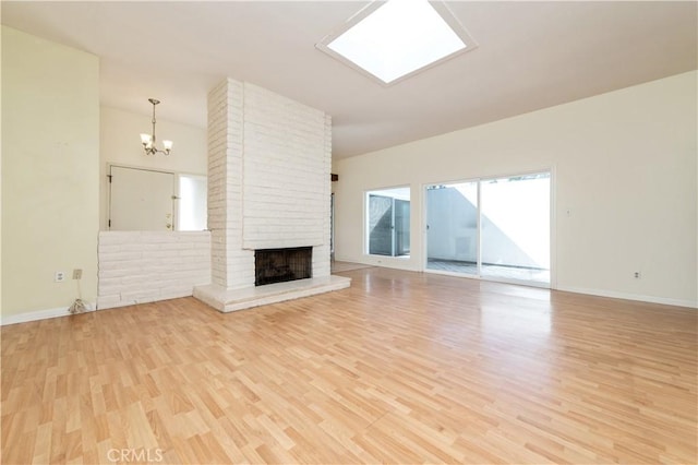 24 Queens Wreath Way, Irvine, CA 92612 - unfurnished living room with light wood-style floors, a chandelier, and a brick fireplace