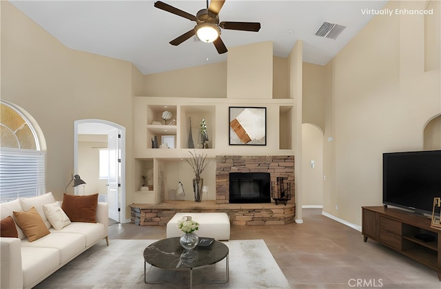 21777 Poppy Rd, Apple Valley, CA 92308 - living area featuring arched walkways, a ceiling fan, a fireplace, and high vaulted ceiling