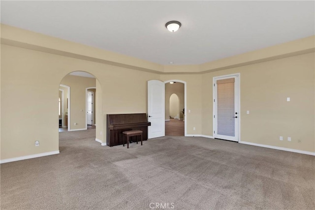 21777 Poppy Rd, Apple Valley, CA 92308 - unfurnished living room with carpet floors and arched walkways