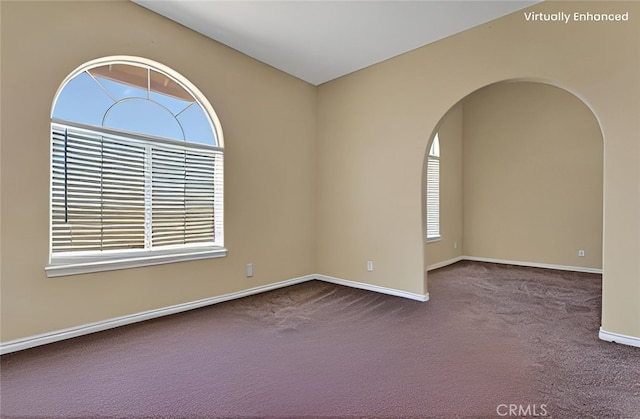 21777 Poppy Rd, Apple Valley, CA 92308 - empty room with plenty of natural light, carpet flooring, and arched walkways