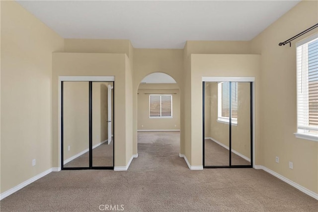 21777 Poppy Rd, Apple Valley, CA 92308 - unfurnished bedroom with carpet flooring, multiple windows, and arched walkways