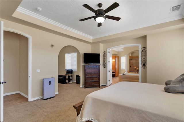 21777 Poppy Rd, Apple Valley, CA 92308 - bedroom featuring arched walkways, light carpet, crown molding, a tray ceiling, and a textured ceiling