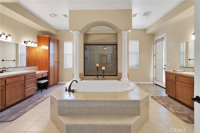21777 Poppy Rd, Apple Valley, CA 92308 - bathroom with ornate columns, a bath, tile patterned floors, and two vanities