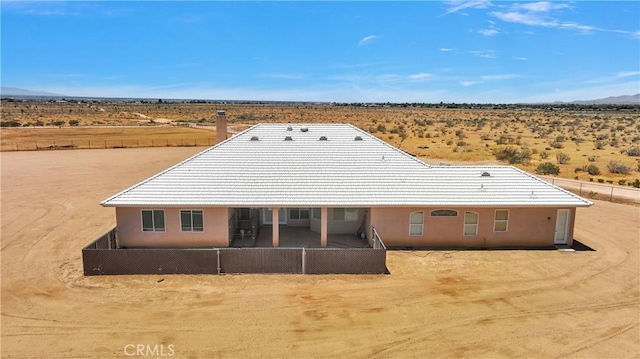 21777 Poppy Rd, Apple Valley, CA 92308 - back of house with view of desert, a mountain view, a view of rural / pastoral area, stucco siding, and a tile roof