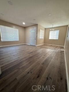 8129 Milna Ave, Whittier, CA 90606 - unfurnished living room with wood finished floors, a chandelier, and recessed lighting