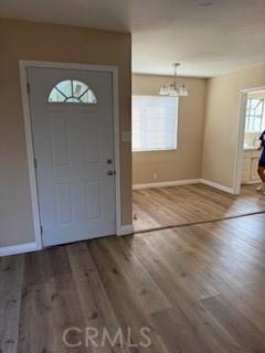 8129 Milna Ave, Whittier, CA 90606 - entrance foyer featuring wood finished floors and a chandelier