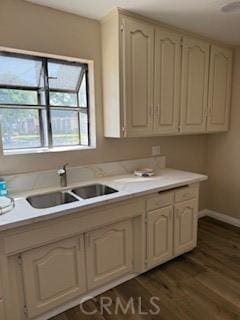 8129 Milna Ave, Whittier, CA 90606 - kitchen featuring light countertops, dark wood-style floors, and cream cabinets
