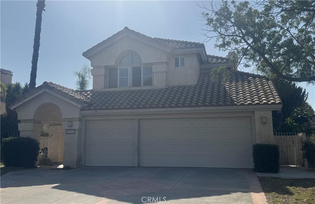 8932 Mesa Oak Dr, Riverside, CA 92508 - mediterranean / spanish-style home with driveway, a tile roof, and stucco siding