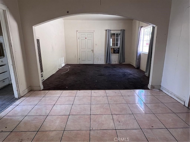 1086 N Bonnie Beach Pl, Los Angeles, CA 90063 - foyer entrance featuring light tile patterned floors, light carpet, and arched walkways