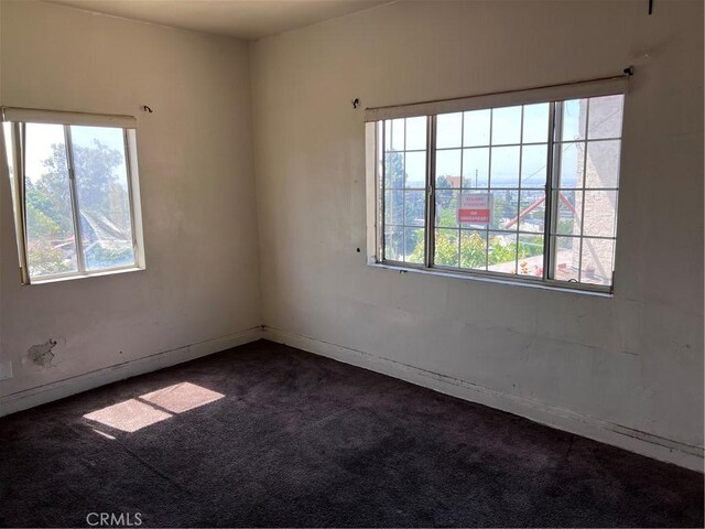 1086 N Bonnie Beach Pl, Los Angeles, CA 90063 - empty room featuring healthy amount of natural light and dark carpet