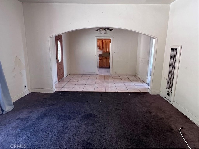 1086 N Bonnie Beach Pl, Los Angeles, CA 90063 - tiled spare room with a heating unit, arched walkways, and carpet flooring