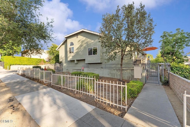 248 E Washington Blvd Unit 4, Pasadena, CA 91104 - view of front facade with a fenced front yard, stucco siding, and a gate