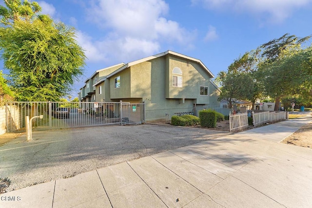 248 E Washington Blvd Unit 4, Pasadena, CA 91104 - view of property exterior with a fenced front yard, stucco siding, and driveway