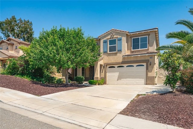 4816 Gregory Rd, Riverside, CA 92501 - view of front of home with stucco siding, an attached garage, driveway, and a tile roof